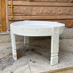 Wooden coffee table with white wash finish .